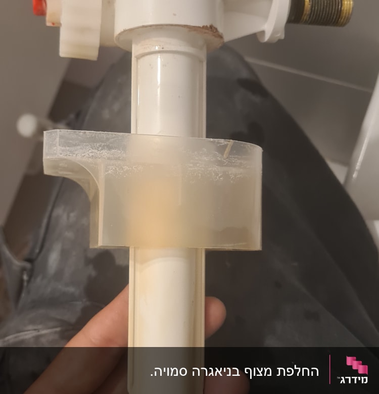 שסתום פלסטיק לבן עם חלקים מתכתיים ביד אדם
